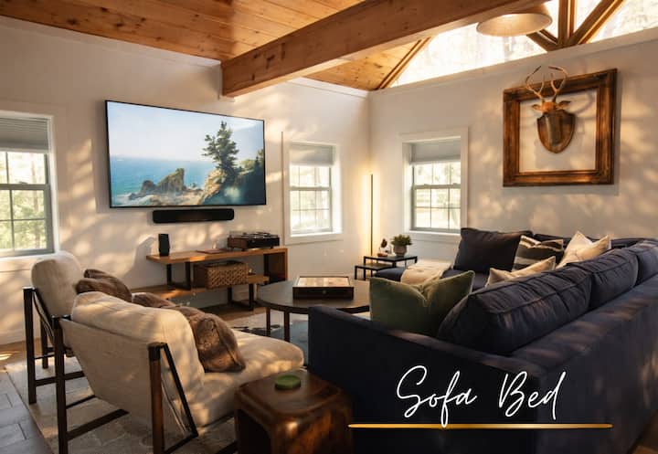 This inviting living room blends rustic charm with modern style, perfect for catching up or just curling up by the windows. Sofa bed available for use for two extra guests.