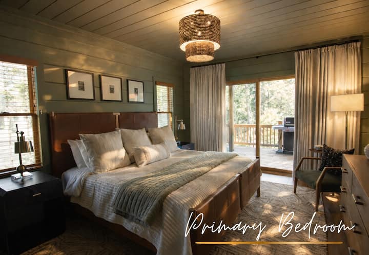 Soft green walls, luxury linens, and a king bed make Bedroom 1 a restful retreat where mornings come slowly.