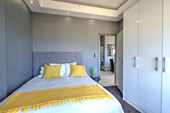 Bedroom: Enjoy a sunlit sanctuary featuring vibrant accents, sleek storage, and elegant touches, creating a warm and stylish space perfect for relaxing and unwinding.