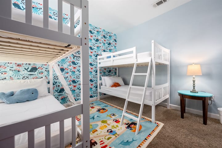 Bekijk de leuke kinderkamer met piraten- en strandthema! 2 sets van twee eenpersoonsbedden.