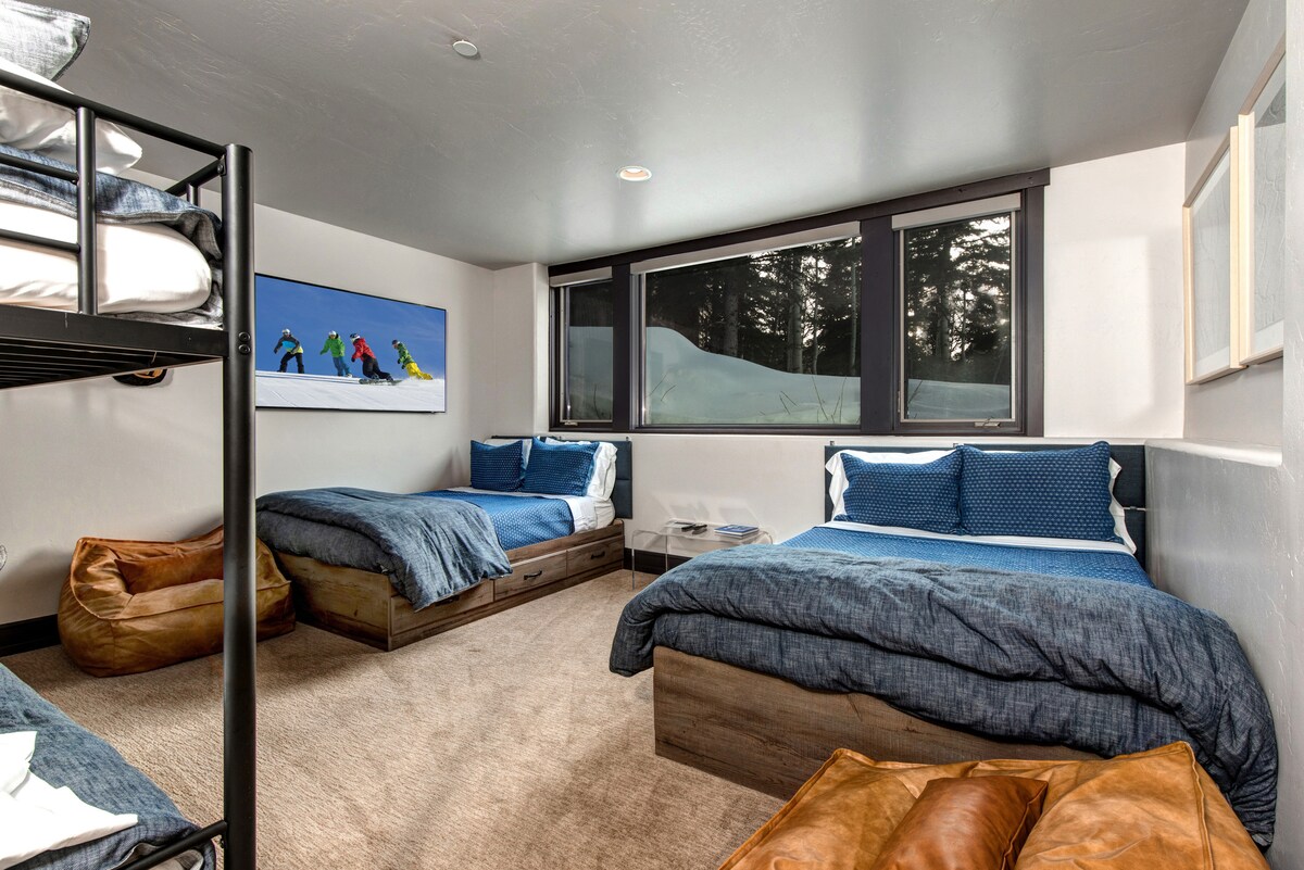 A bedroom with a bunk bed and two twin-size beds.