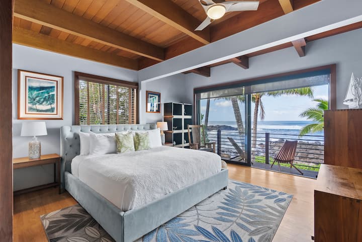 Guest bedroom featuring a king-size bed and stunning water views.