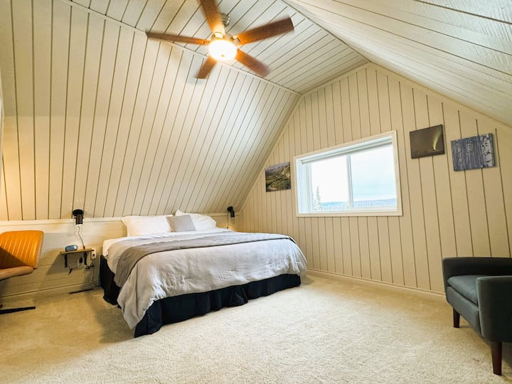 La chambre n °1 à l'étage est spacieuse et dispose d'un grand lit et d'une vue sur la carte postale depuis les grandes fenêtres.