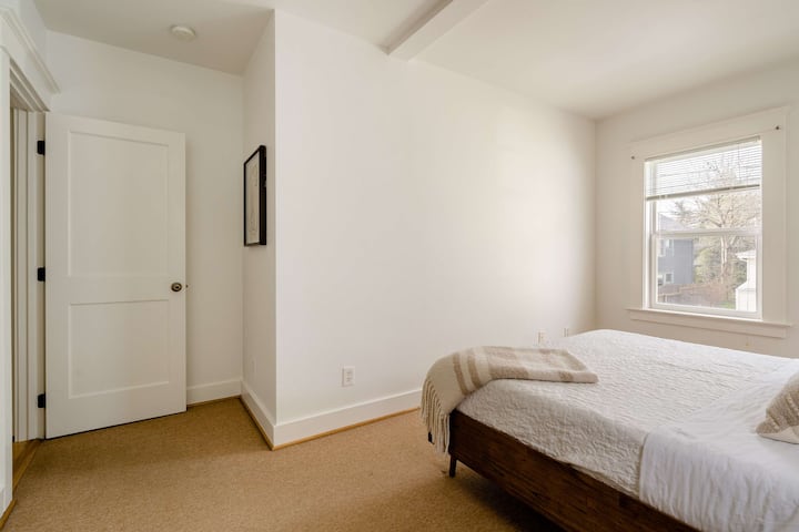 Bedroom with a window and open door.