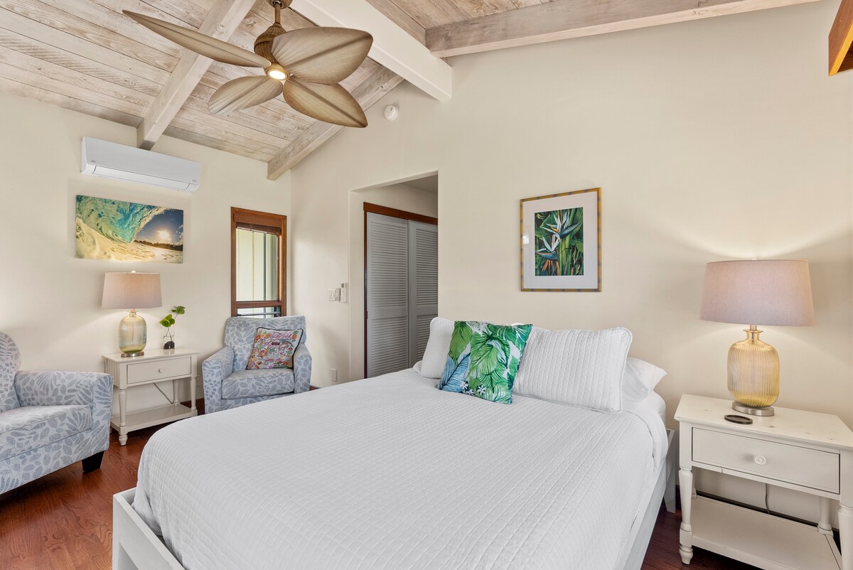 Tranquil bedroom with a queen-size bed, vaulted ceilings, and soft natural light.