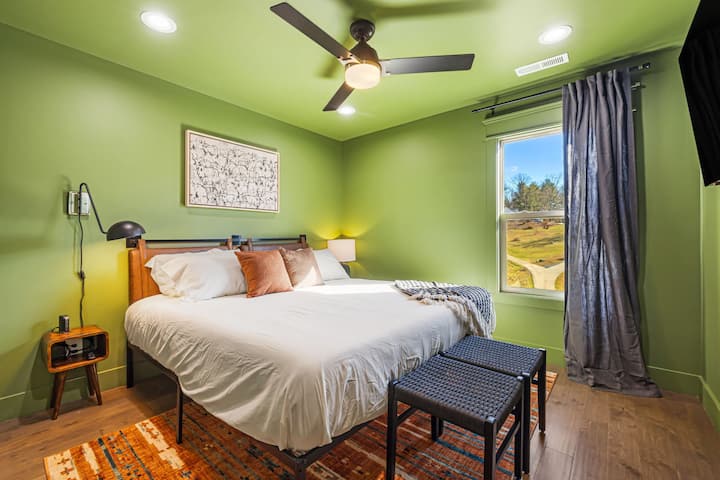 Veliki bračni krevet s USB konzolama na stolićima i TV-om od 50 inča na gornjoj etaži