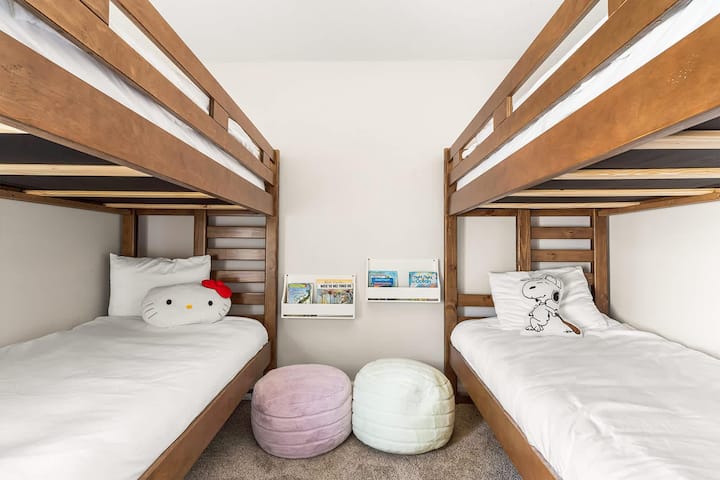 Acogedora habitación con literas y divertidos asientos de felpa para niños
