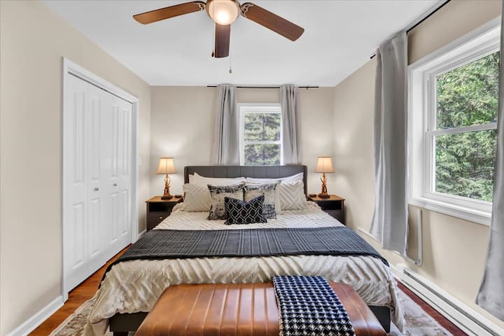 Unwind in a sun-washed queen suite where blackout curtains and a ceiling fan promise the perfect night’s sleep.