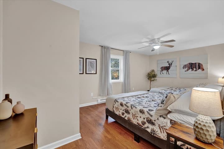 Drift into slumber beneath woodland prints and soft linens that channel cozy cabin vibes without leaving town.