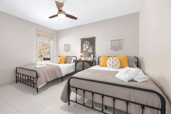 Chumba chetu cha kulala cha pili kina vitanda viwili vya ukubwa wa Queen, eneo la dawati na bafu la karibu.