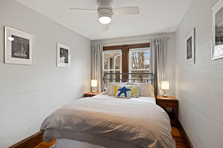 Plush Queen bedroom with overhead ceiling fan