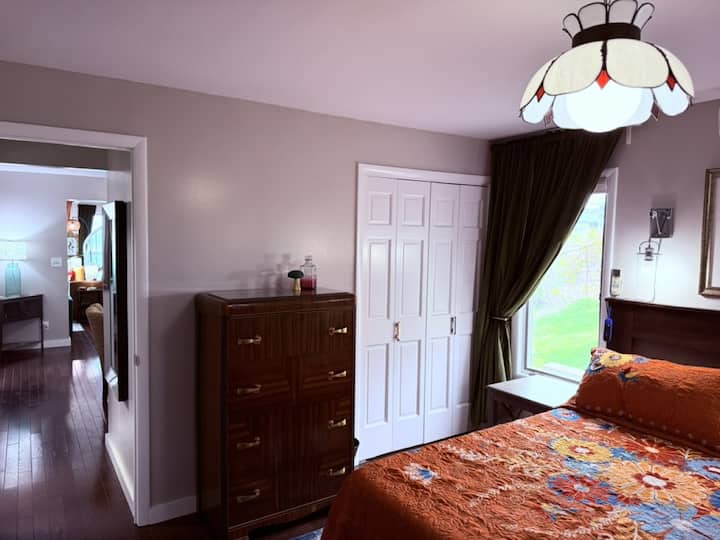 The secondary bedroom is has a king bed and is cozy with a mid-century, yet bohemian vibe—a great fit for anyone.
