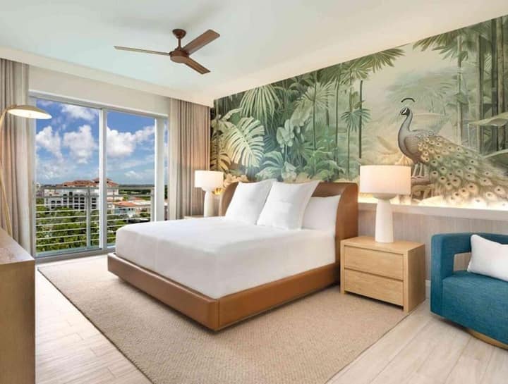 Drift off beneath a bold mural in a tranquil bedroom.