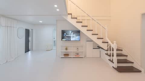 Clean accommodation with white interior, Pine Tree Private Group Room