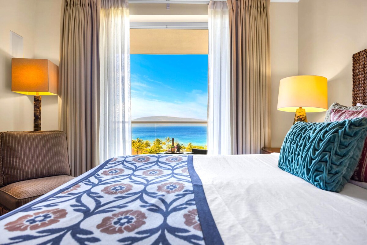 Ocean-facing guest room with King bed and plush carpeting.