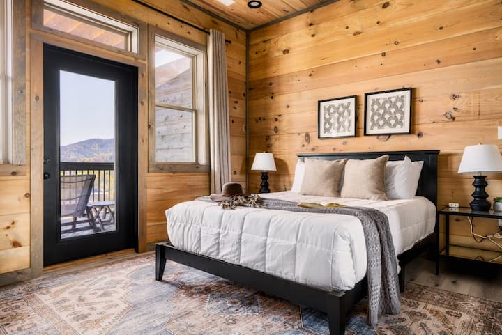 Lower level queen bedroom with an ensuite bathroom, TV and luxury linens