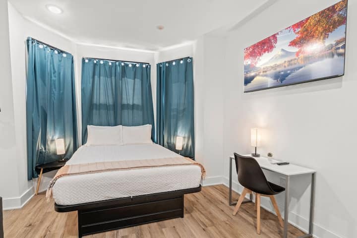 This comfortable bedroom features a double-sized bed and a sofa bed, making it ideal for small groups or families. It also includes a TV for entertainment and a dedicated workstation for added convenience.