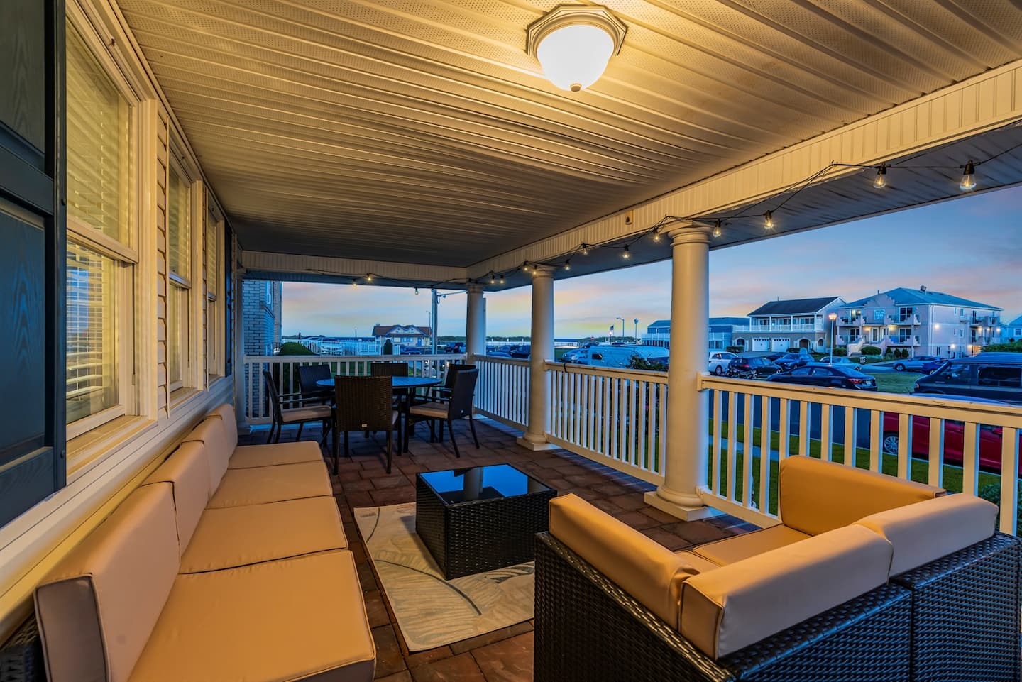 The wraparound porch furnished for lounging, first angle