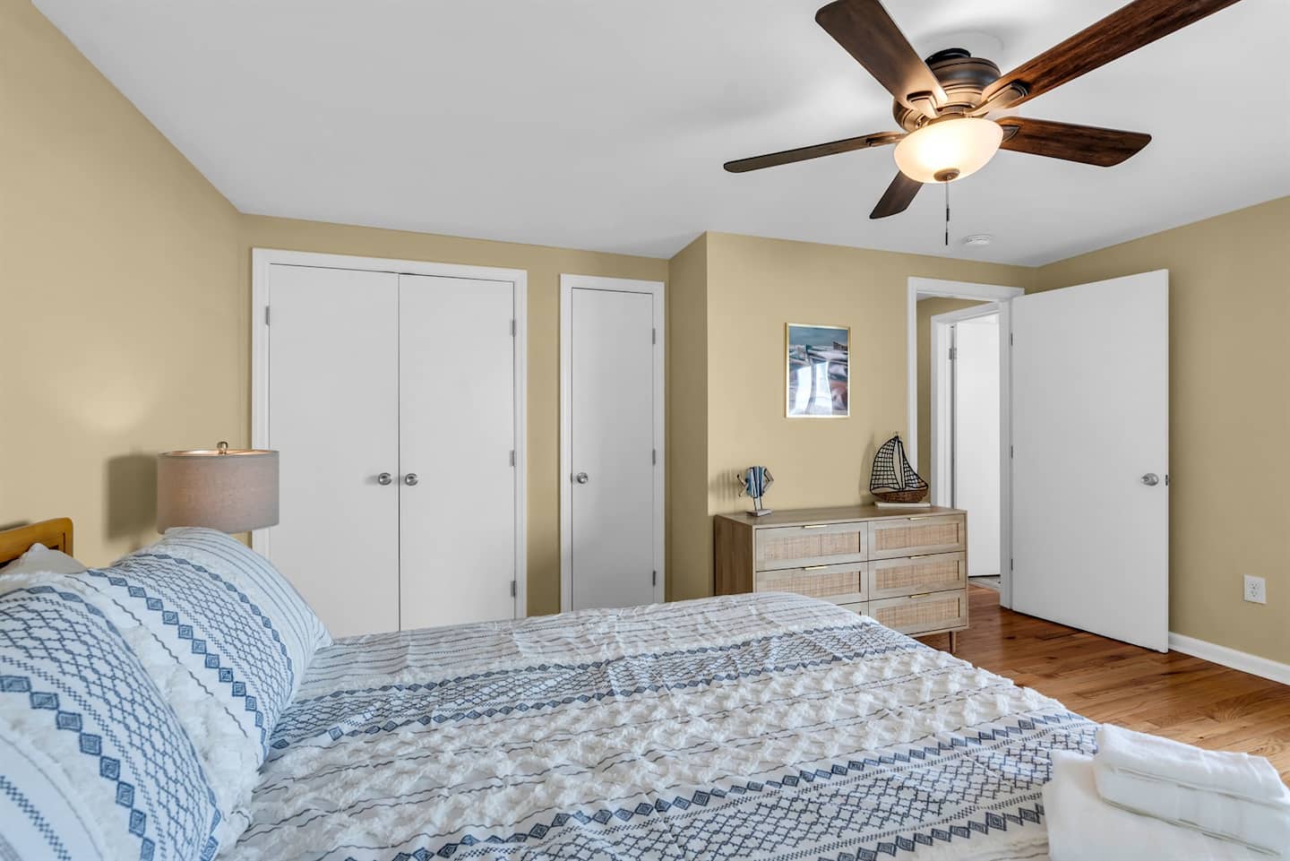 Breezes inside and out with cold A/C window units, ceiling fan and natural light.