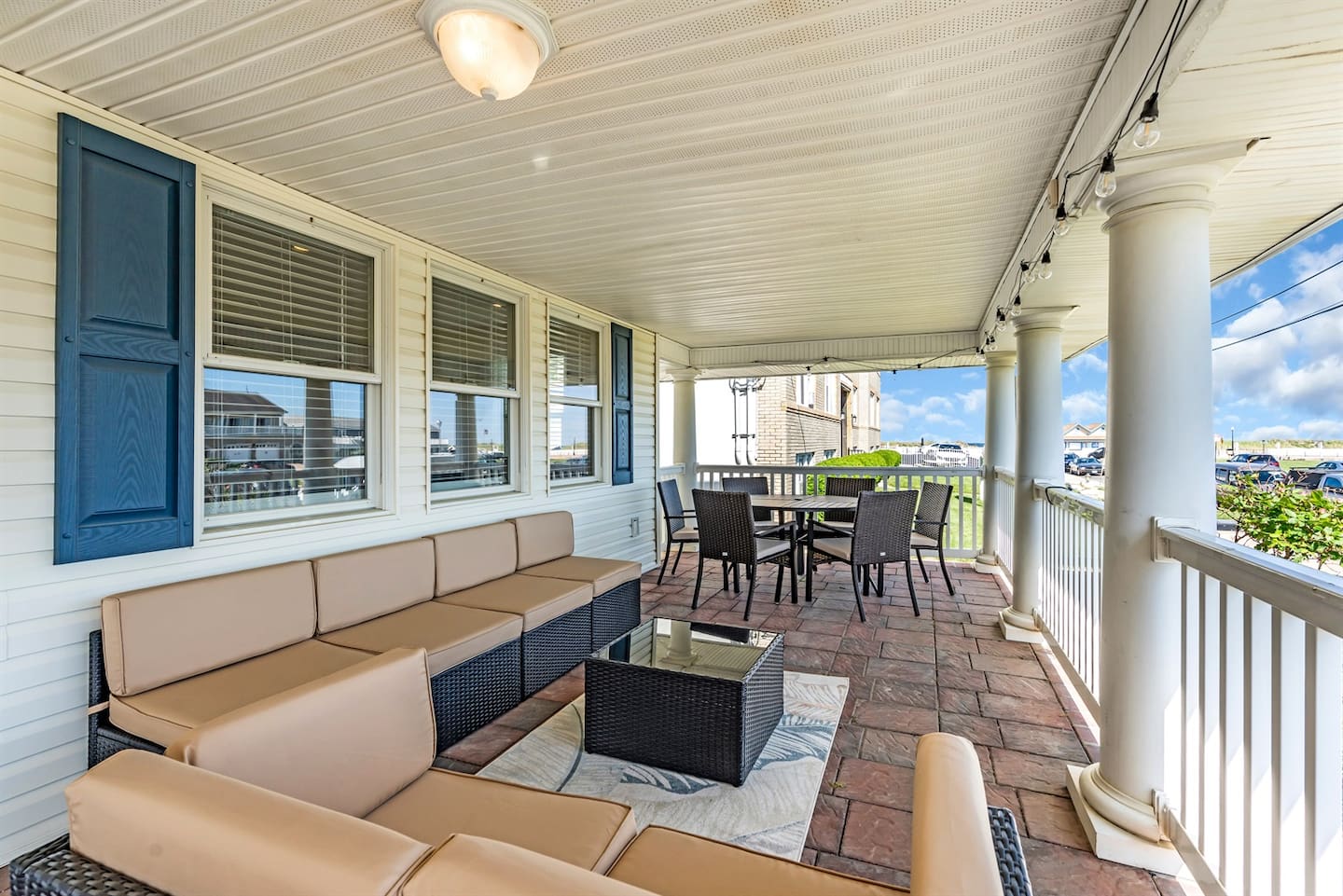 Soak up ocean breezes from this spacious wraparound porch, complete with plush seating and a dining area ideal for morning coffee or sunset cocktails.