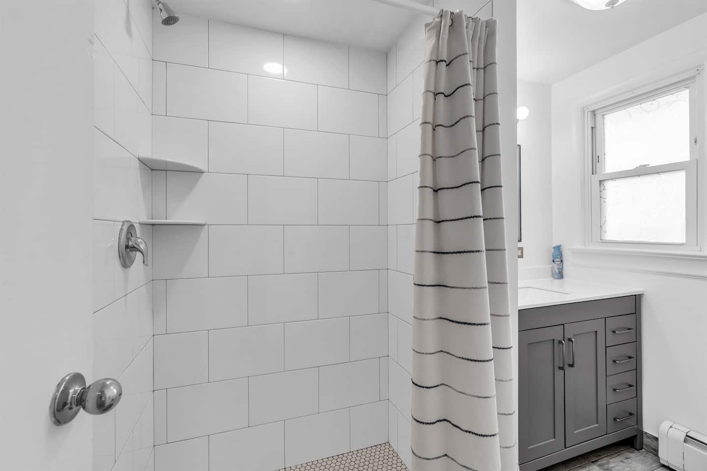 Beautiul bathroom with generous amounts of toilet paper, shampoo, conditioner and body wash.