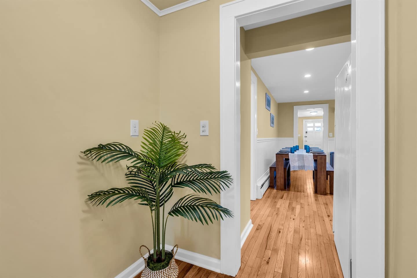 Step into a warm, welcoming entryway that leads to a beautifully set dining space, perfect for gathering with family or friends.