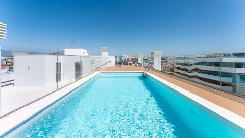 Modern 2BR w/ Rooftop Pool & Parking by LovelyStay