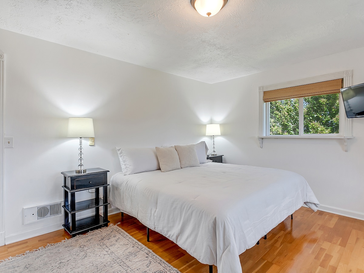 Bedroom 2 alternate angle showing king-size bed and natural light