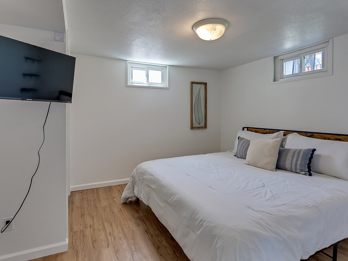  Bedroom 6 with king bed, mounted TV, and private lower-level setting for added quiet and privacy