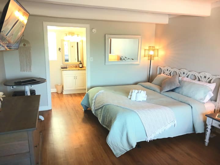 Descanse tranquilamente en la espaciosa recámara con una lujosa cama king, sábanas frescas y una relajante decoración costera.