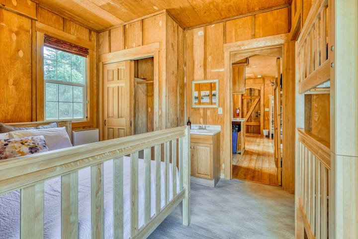 Charming Bedroom: Enjoy rustic wood accents, a cozy bunk, and views of nature right outside!