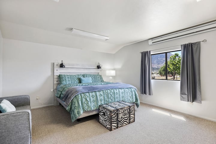 Svegliati con la vista sulle montagne in questa tranquilla camera da letto con letto king size e accoglienti dettagli rustici.