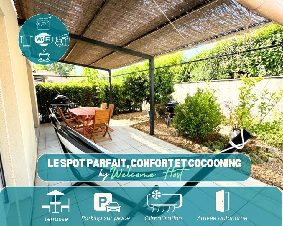 An outdoor terrace is seen, framed by lush greenery. The space includes a wooden dining table accompanied by several chairs, as well as a barbecue grill. A shaded area is provided by a pergola, creating a comfortable setting for outdoor meals and relaxation.
