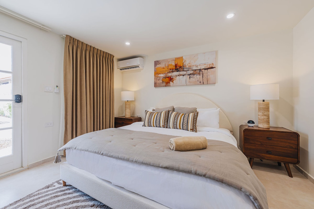 Bedroom 5 is a private garden suite featuring a luxurious king-size bed, complete with full privacy and a beautifully appointed ensuite bathroom, creating an exclusive retreat.