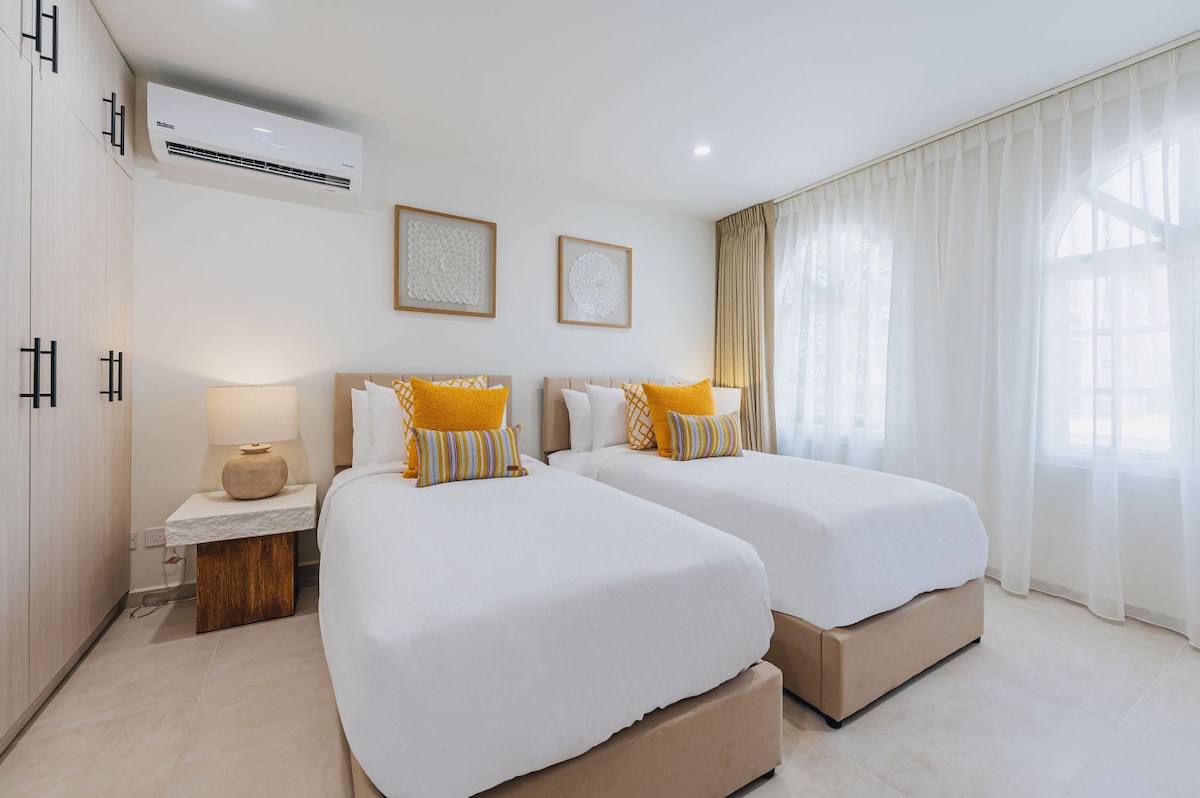 Elegant bedroom featuring twin beds designed for unparalleled comfort and a truly restful night’s sleep.
