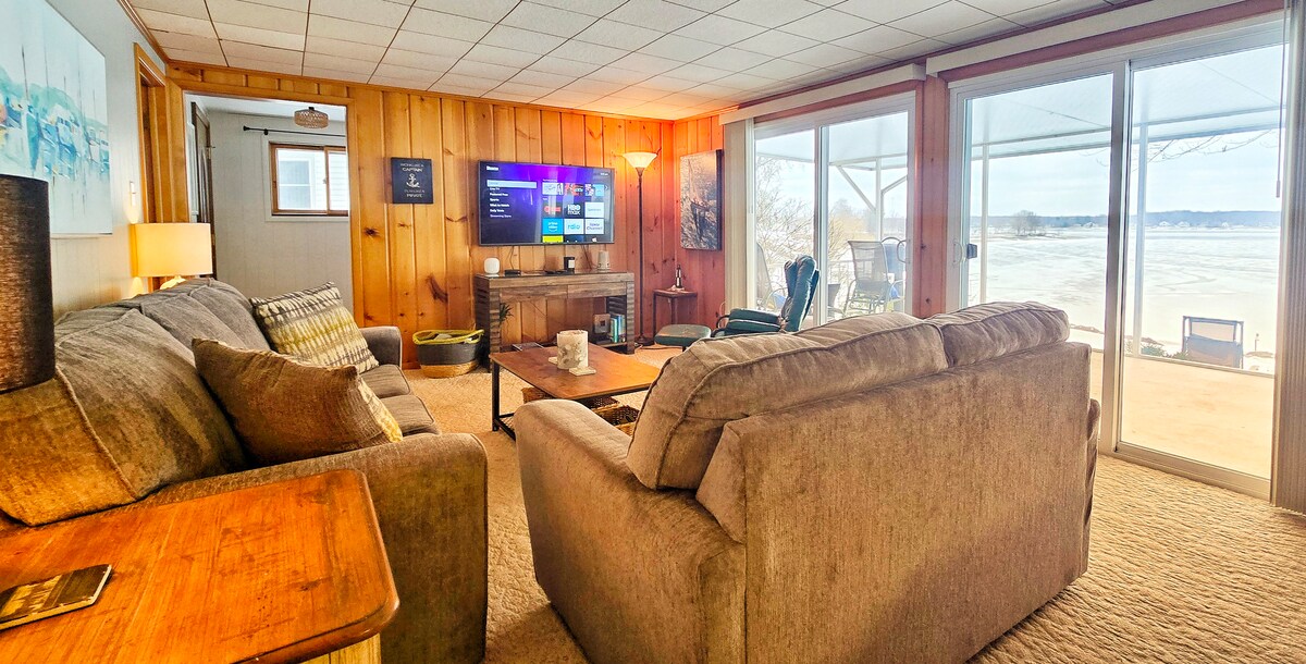 Cozy lakefront lounge with smart TV and walk-out patio views.