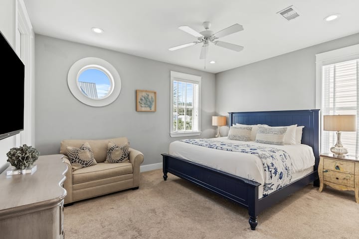 Chumba cha kulala cha msingi kina kitanda aina ya king, runinga, kitanda cha siku mbili na bafu la malazi.