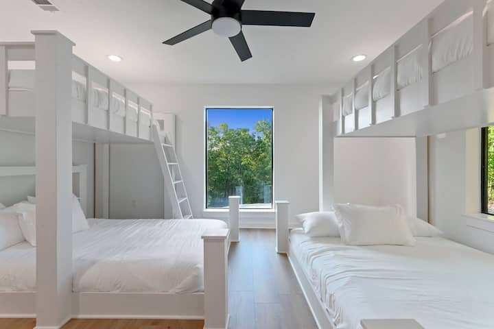 Bunk room featuring 2 queen beds (bottom) and 2 full beds (top). Sleeps 6 comfortably.
