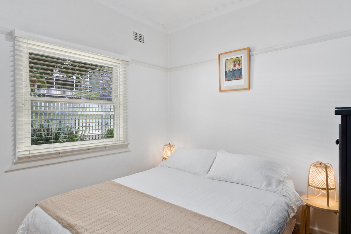 The second queen bedroom includes handy storage and enjoys soft natural light throughout the day.