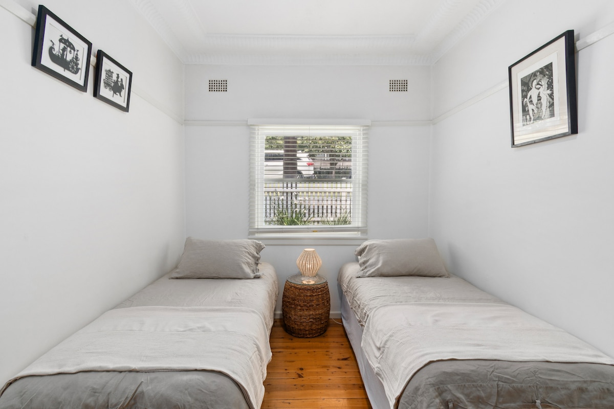 The third bedroom features two single beds, perfect for families or friends.