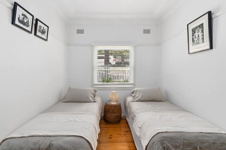 The third bedroom features two single beds, perfect for families or friends.