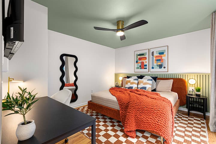 Designed for comfort and productivity, this room includes a 55" Smart TV, dedicated work station, full-size mirror, and closet—ideal for remote work or quiet relaxation.