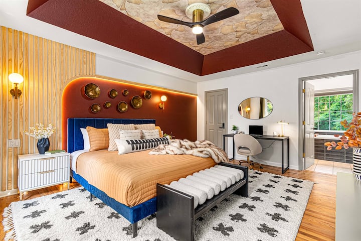 Master Bedroom Features  a 65" Smart TV, dedicated work station, closet, and full-size mirror, it’s the perfect space for unwinding after a long day of hiking or exploring Asheville.