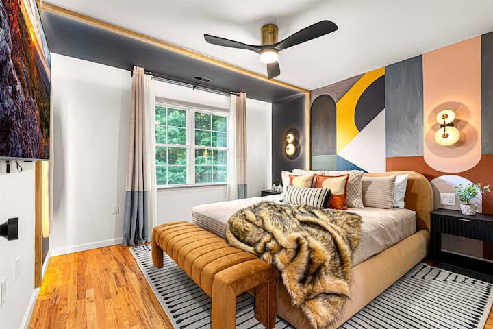 Layered lighting and unique design details give this space its eclectic flair—featuring bedside lighting, 65" TV, full-size bed, and a spacious closet for a comfortable stay.