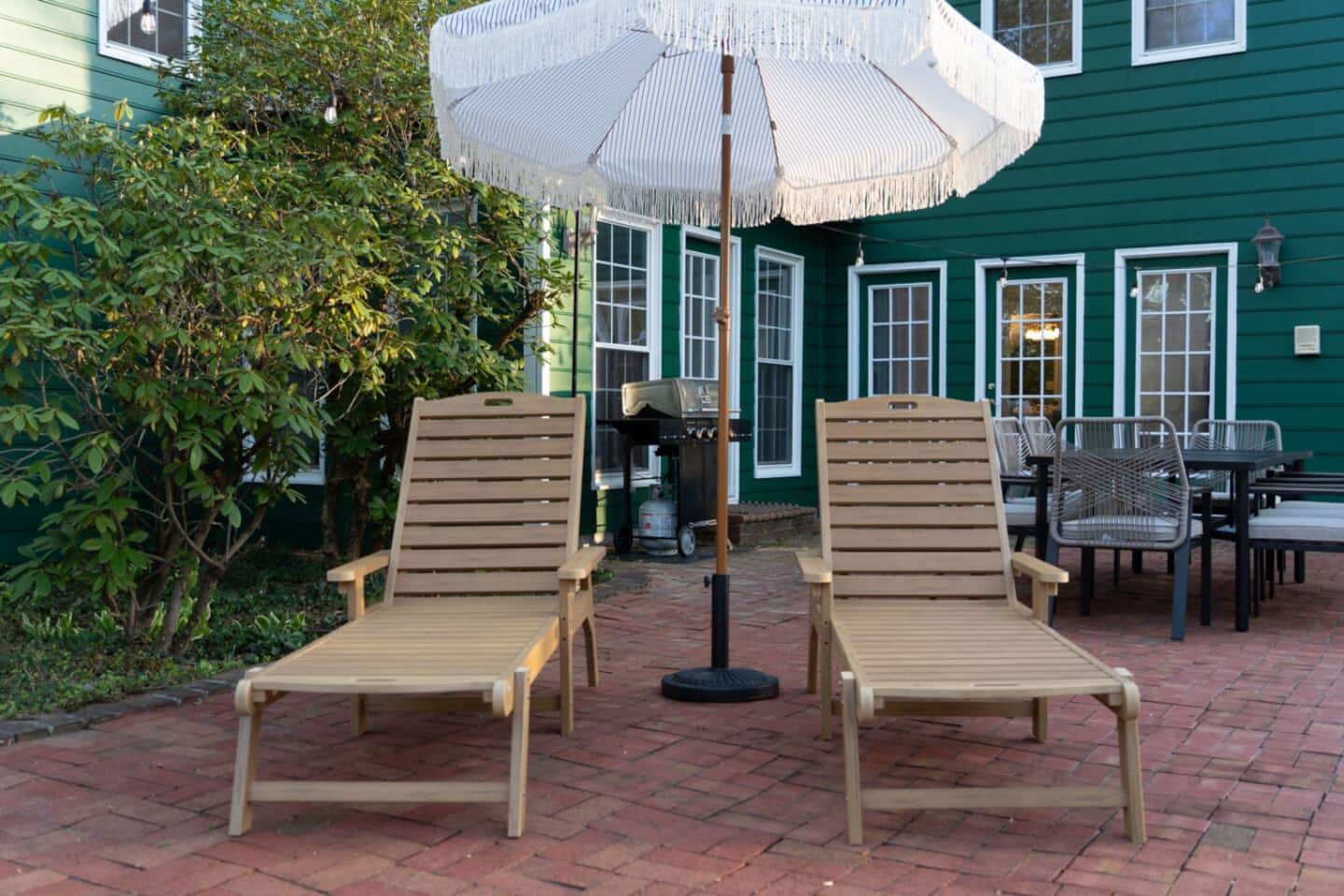 Lounge chairs under umbrella by the pool
