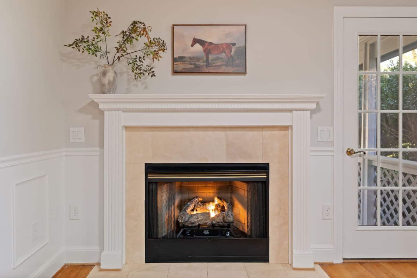 Living room fireplace with mantel and French doors