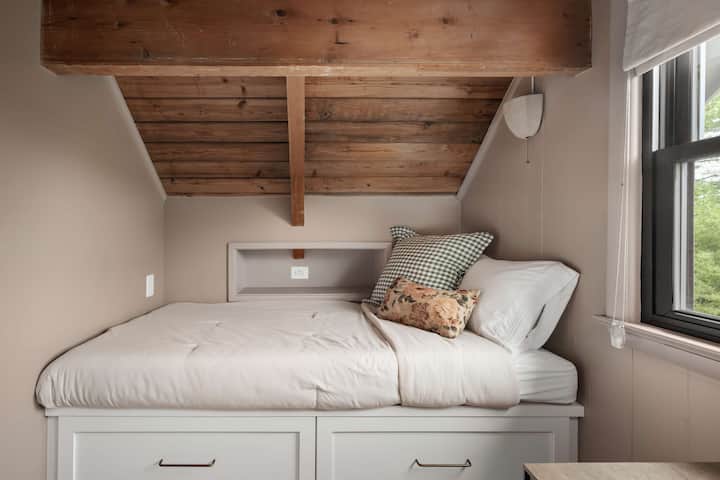 Second view of the twin room showing two comfortable beds and simple, clean design and niches with USB ports.