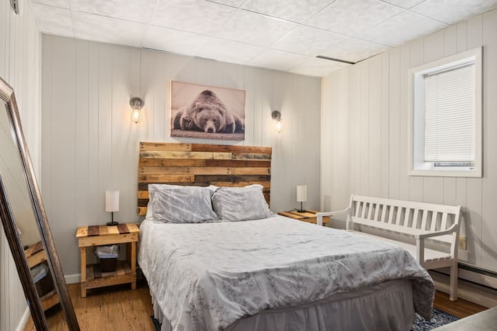 Cozy bedroom with bed and rustic wooden headboard for a restful mountain retreat