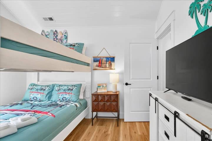 Conveniently situated off the main hallway, this bunk room offers a queen-over-queen bunk bed, thoughtful storage space, and a Roku Smart TV for streaming your favorite shows.