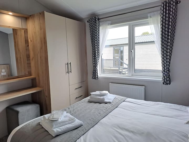 Chambre principale avec coiffeuse et dressing spacieux.